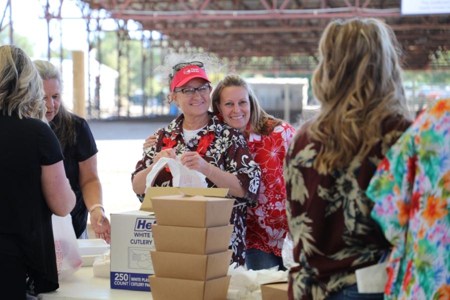 Two people smiling and hugging. 