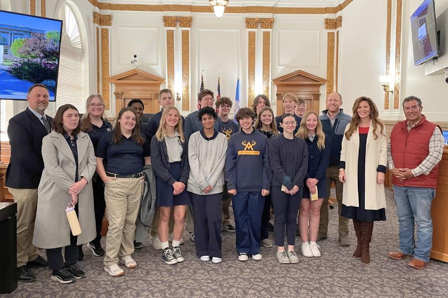 A large group of people smiling. 